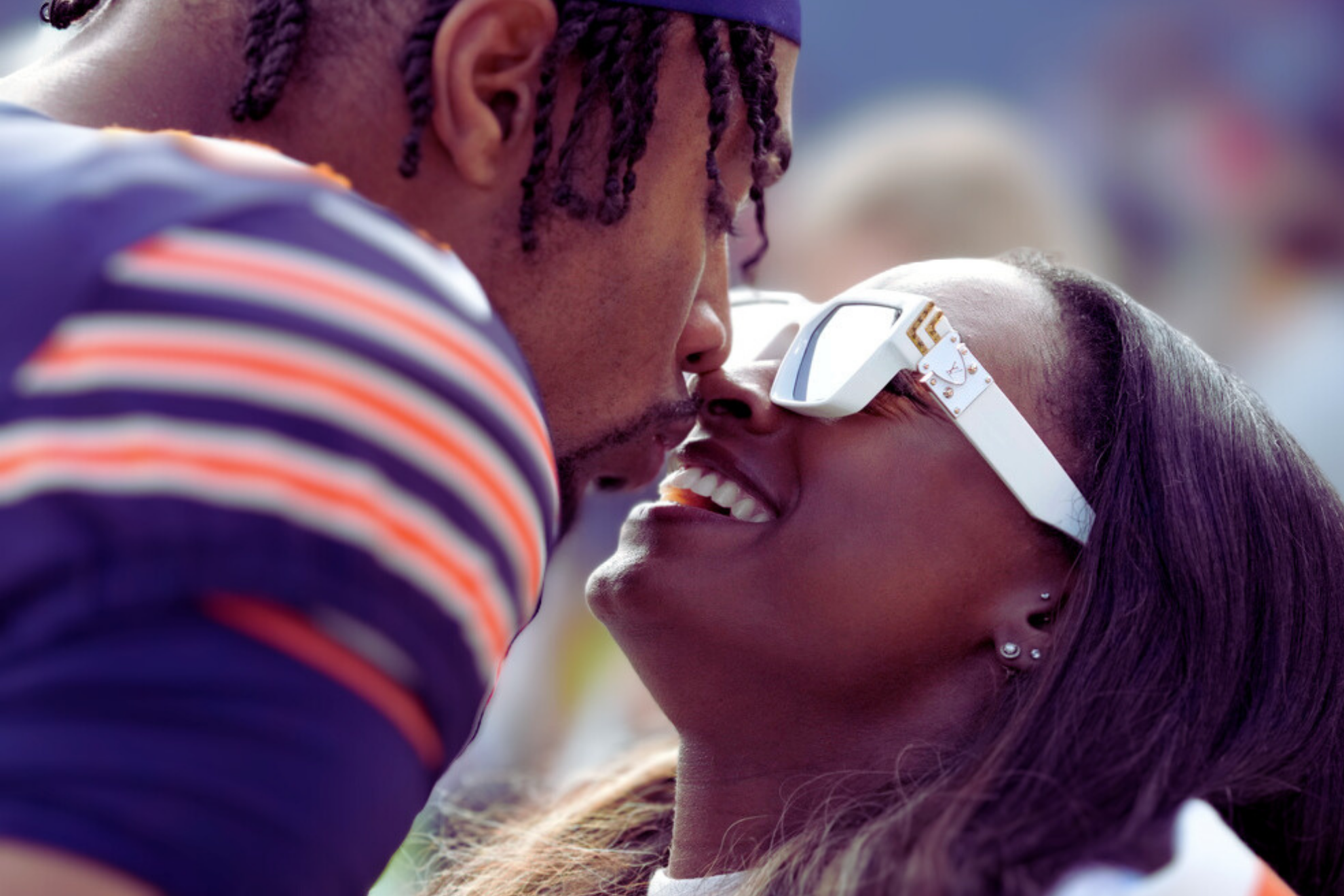 Chicago Bears safety Jonathan Owens kisses his wife Simone Biles before an NFL football game against the New England Patriots.