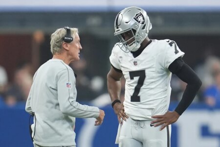 Pete Carroll protects Geno Smith while shooting at the rest of his Raiders teammates