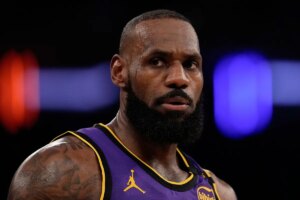 LeBron James brushes off a fan who appeared to be mocking him while Carmelo Anthony soaks in the moment