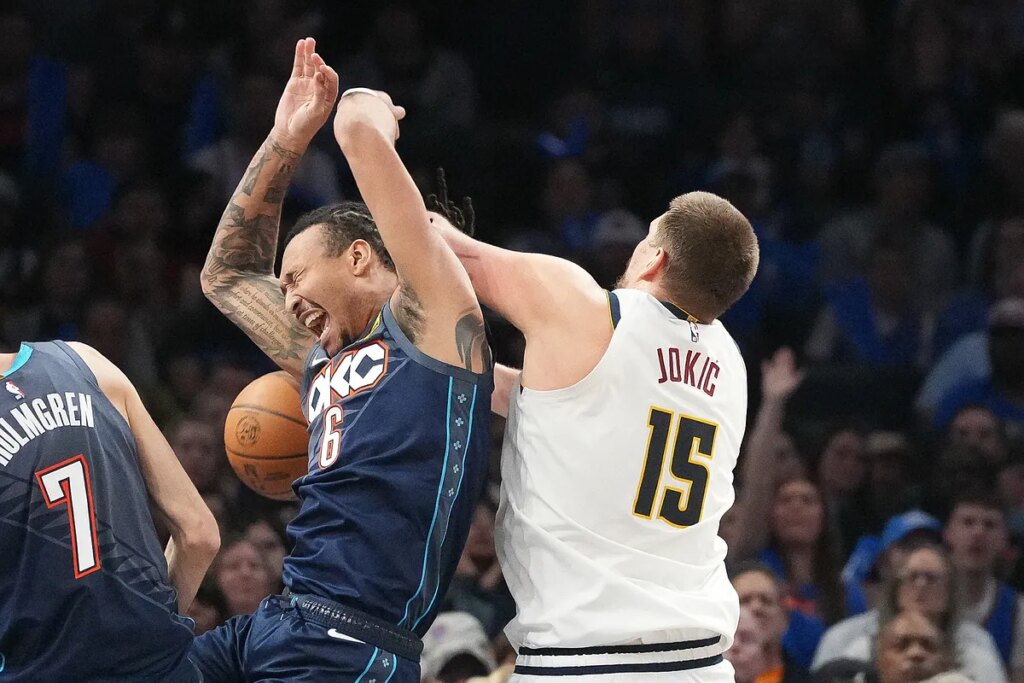 Nikola Jokic throws an elbow and reacts angrily after an unsportsmanlike play by Thunder Lu Dort