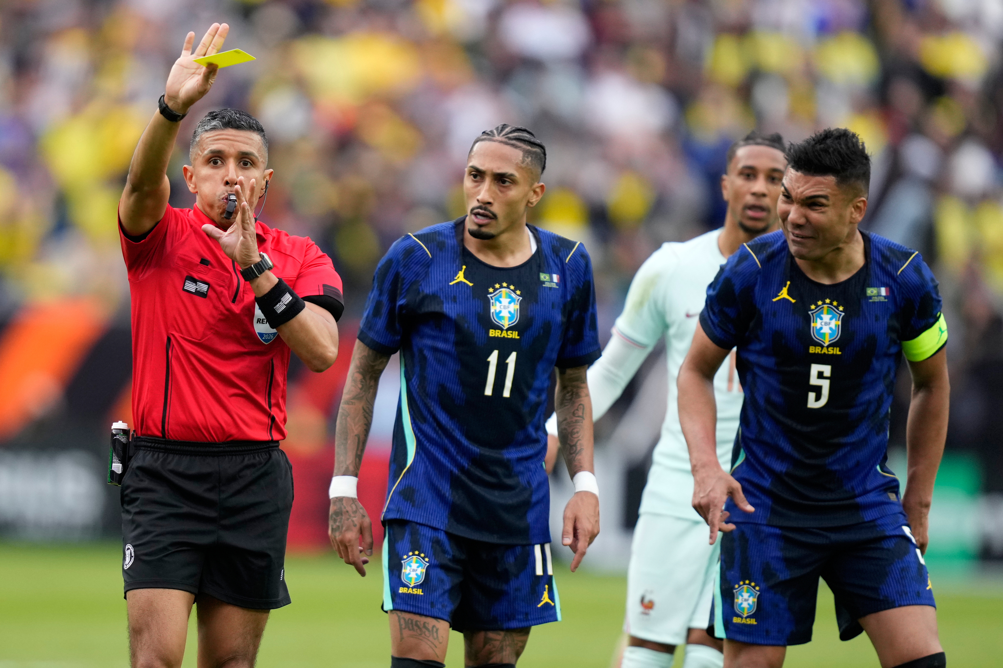 Brazil's Raphinha and Casemiro, right, remonstrate with referee Guido Gonzales Jr. during the international friendly soccer match between Brazil and lt;HIT gt;France lt;/HIT gt; in Foxborough, Mass, Thursday, March 26, 2026. (AP Photo/Charles Krupa)