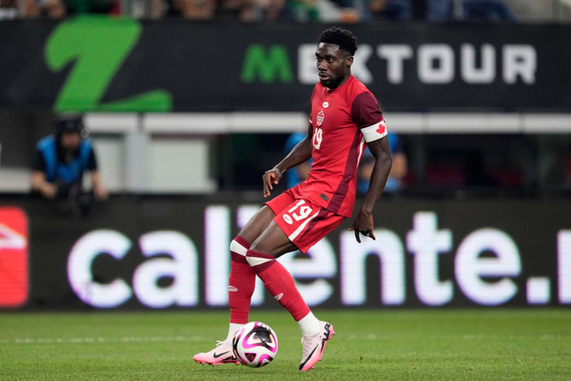 Canada defense man Alphonso Davies controls the ball